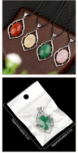 Detail of leaf-shaped crystal pendants in various colors with rustic wooden background