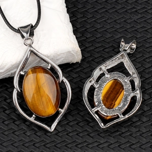 Tiger's eye stone pendant necklace with oval gem and hollow metal frame on black cord