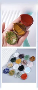 Handheld view and assortment of teardrop shaped polished natural crystal thumb stones
