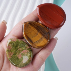Polished teardrop worry stones set in red jasper, tiger eye, and unakite for palm massage