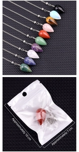 Detailed view of assorted crystal teardrop pendants with silver chains and packaging
