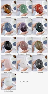 Macro shot of various natural crystal palm stones with engraved compass star symbols