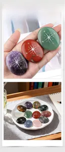 Detailed view of colorful natural crystal palm stones with silver compass engravings