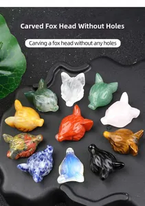 Macro shot of assorted gemstone fox head carvings including rose quartz and tiger eye stones