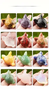 Detailed grid of twelve hand-carved gemstone wolf head figurines in various natural minerals