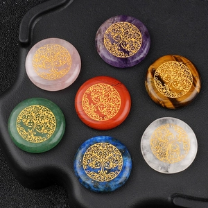 Set of seven polished 25mm tree of life natural gemstones on black textured tray