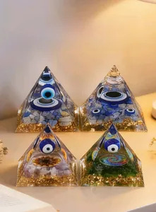 Detail showing 6cm resin Evil Eye Orgone Pyramid with blue gravel and gold foil flakes