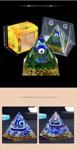 Detail of resin Evil Eye orgone pyramid with gold foil and Egyptian themed packaging