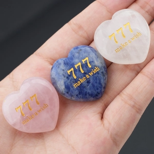Three natural crystal heart stones with golden 777 engraving for meditation and decor