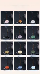 Various natural crystal lotus incense holders shown with burning incense sticks
