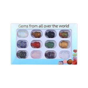 Set of 12 hand-carved natural gemstone turtles in a blue gift box with various crystals