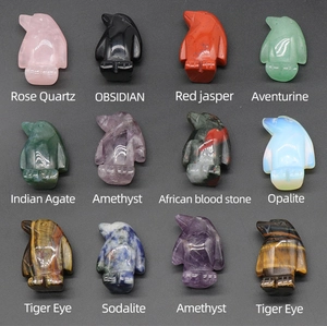 Detailed assortment of twelve mini penguin carvings in various natural semi-precious stones