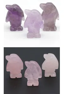 Detailed view of hand-carved penguin figurines in amethyst and rose quartz stones