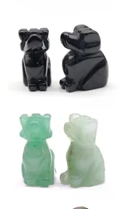 Detailed view of hand-carved obsidian and green aventurine stone puppy dog figurines
