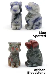 Detail of hand-carved stone dog figurines in blue spot and African blood stone