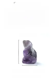 Detailed macro shot of 1-inch purple amethyst bird figurine with natural crystal textures