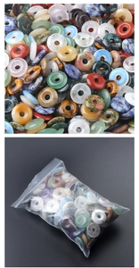 Close-up of polished natural gemstone donut beads with colorful mineral textures