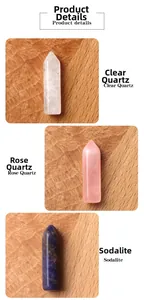 Detail view of Clear Quartz, Rose Quartz, and Sodalite hexagonal crystal pillars on wood
