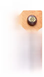 Detailed view of six natural chakra stones with engraved gold symbols on wood background