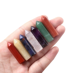 Set of seven natural crystal hexagonal prisms held in hand with polished finish
