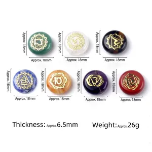 Set of 7 natural chakra healing crystals with golden symbols on a clean white background