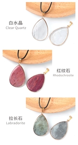 Detail of teardrop quartz, rhodochrosite and labradorite pendants with gold bails
