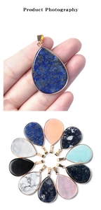 Detailed macro shot of teardrop gemstone pendants with elegant gold plated metal borders