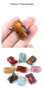Detailed view of hand-carved lizard figurines made from natural tiger eye and rose quartz