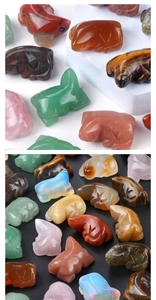 Macro detail of various hand-carved natural crystal animal figurines in multiple colors