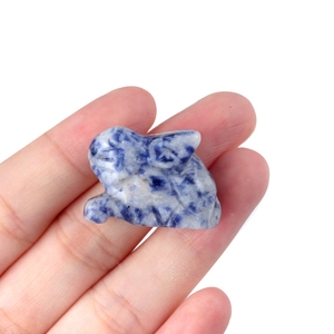 Miniature natural sodalite rabbit statue with blue marble texture held in hand