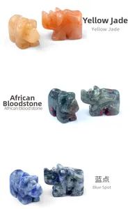 Detailed view of hand-carved crystal rhino ornaments in assorted natural gemstones