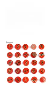Detailed view of red jasper stones engraved with golden Runes and natural textures