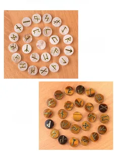 Detail view of Clear Quartz and Tiger Eye Rune Stones with golden engraved symbols