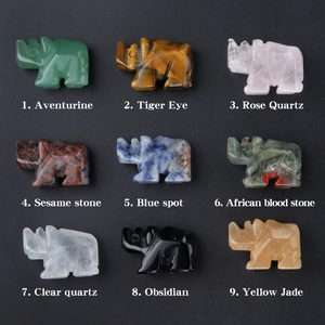 Nine mini gemstone rhino figurines carved from tiger eye, quartz, and obsidian stones
