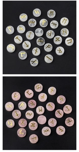 Macro shot of clear and rose quartz Rune stones with gold engraved Nordic alphabet