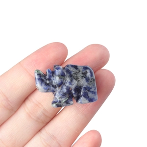 Miniature hand-carved sodalite rhino figurine made of blue and white natural gemstone