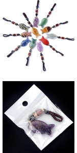 Macro detail of various fish-shaped natural crystal pendants with hand-woven ropes