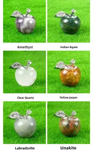 Macro detail of various 25mm natural crystal apple carvings with silver metal leaves