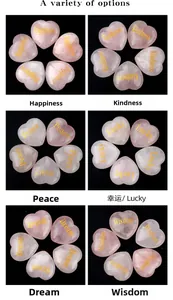 Macro view of five pink rose quartz heart stones with gold engraved inspirational words