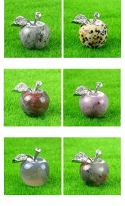 Various carved gemstone apples featuring natural crystal patterns and metallic leaf accents