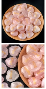 Macro view of polished pink heart quartz stones with golden engraved inspirational words