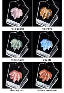 Macro view of maple leaf shaped quartz and agate pendants in various gemstones