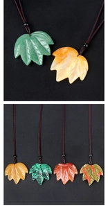 Detailed view of maple leaf pendants carved from natural crystals and agate stones