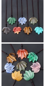 Macro detail showing diverse crystal maple leaf pendants with hand-carved leaf veins