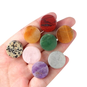 Polished 16-18mm natural agate and crystal stone round cabochons held in hand