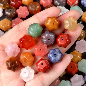 Farbenfrohe kürbisförmige Naturkristallperlen in der Hand für DIY-Schmuckherstellung