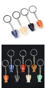 Macro view of assorted carved angel keychains in colorful natural stone textures