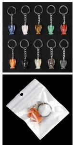 Detailed view of angel crystal keychains in various stones with packaging detail