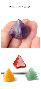 Detailed view of hand-held natural amethyst crystal pyramid energy home decor pieces