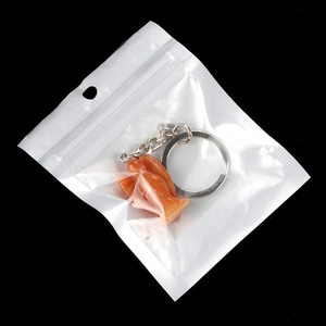 Orange crystal angel keychain pendant with silver metal ring in clear packaging